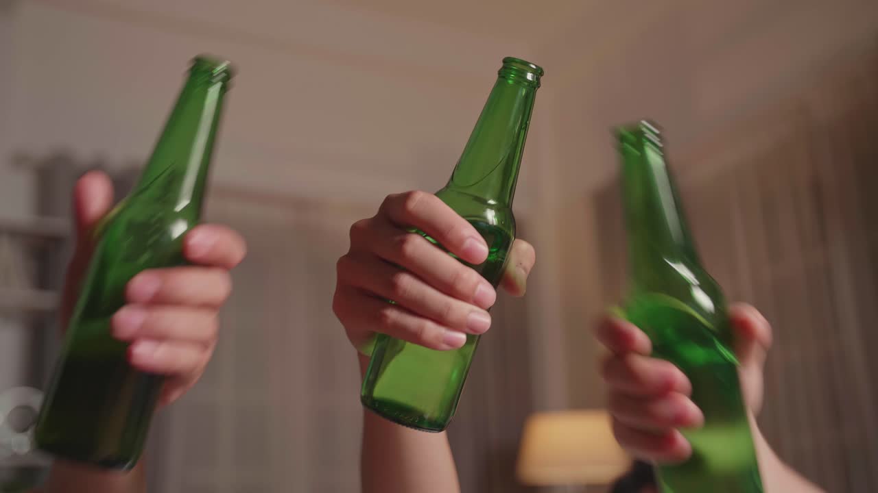 Friends toasting with beer bottles