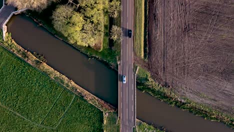 aerial view of a dutch countryside road and canal with farmland