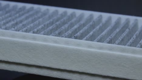 close-up of a carbon charcoal cabin car air filter rotating in the dark