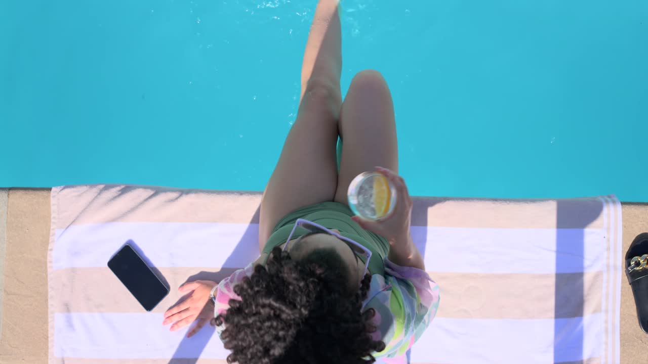 Woman pressing hands down at pool, starting leg paddling, sipping cup, ripples animating for travel