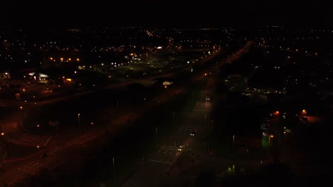 nighttime traffic headlights driving rural british town highway intersection aerial view