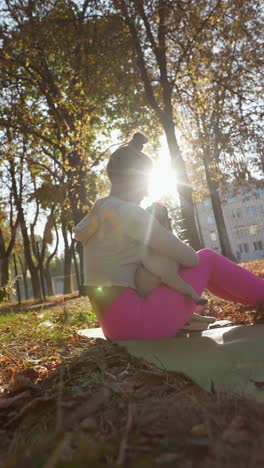 woman hugging a pug in a park