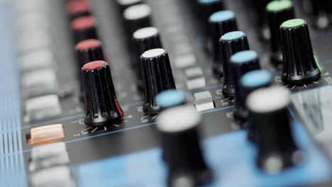 An-equalizer-on-a-mixing-console-is-operated