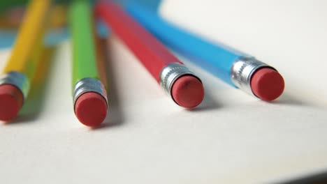 colorful pencils on notebook