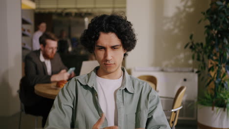 a man working on his laptop in a cafe