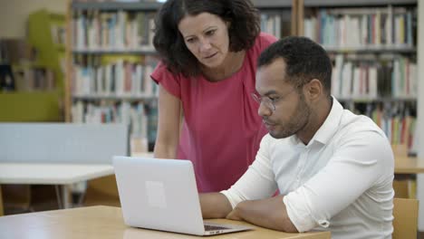 Two-professors-discussing-new-academic-plan-at-library