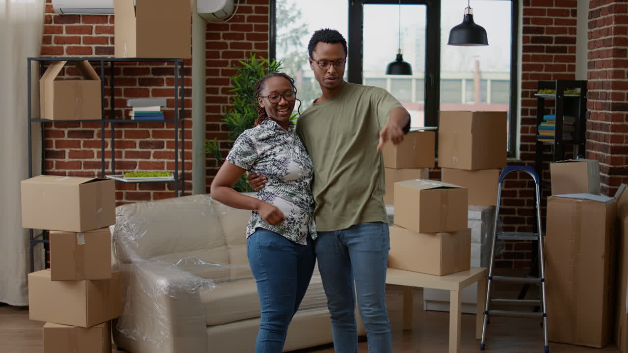 African american couple hugging and feeling happy about house relocation