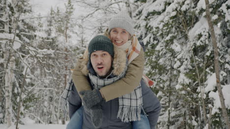 Couple Having Fun in a Snowy Forest