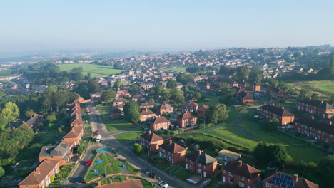 The-UK's-Dewsbury-Moore-Council-estate,-captured-by-a-drone:-red-brick-homes-and-the-Yorkshire-industrial-scene-on-a-sunny-summer-morning