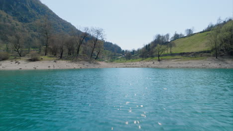 Flyover-Turquoise-Water-Of-Lago-di-Tenno-At-Tenno-In-Trentino,-Italy-During-Summer