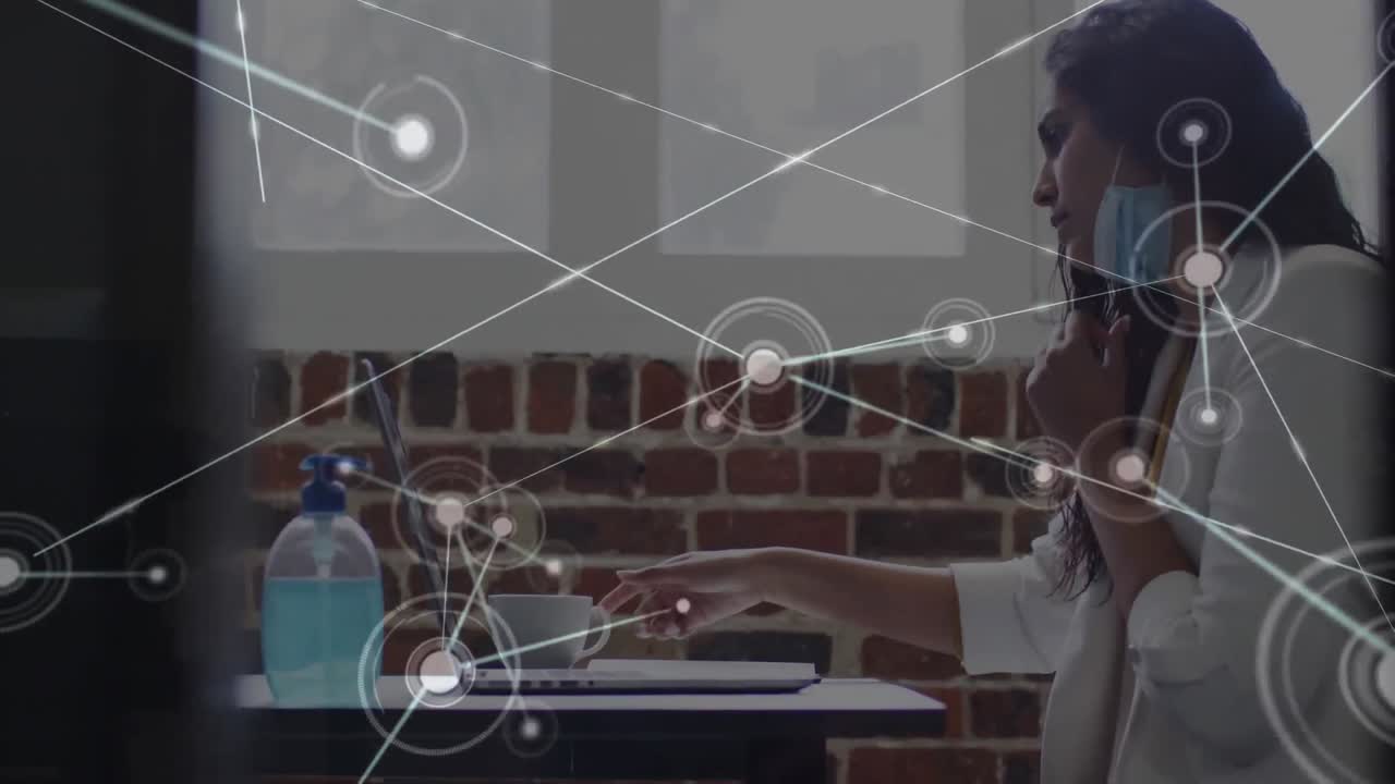 Digital composite video of network of connections against indian woman drinking coffee at office