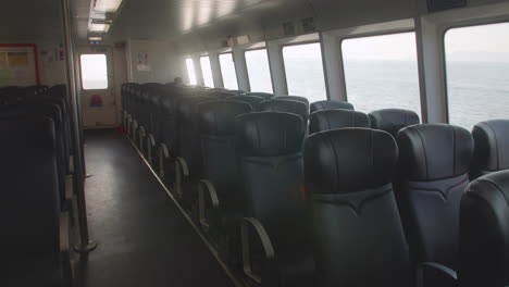Beautiful steady shot of ferry leather empty seats. No tourists. HDR cinematic. Boat navigating on Victoria Harbour, Hong Kong.