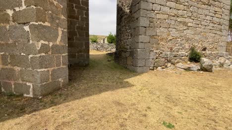 filming of a small stone bell tower with its two holes for the bells and separated by a corridor is a medieval sanctuary, we appreciate its robust carved stone buttresses, all in slow motion