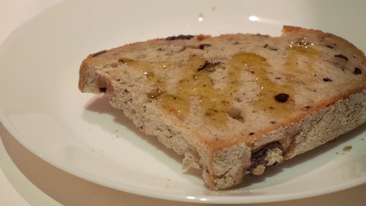 Healthy toast with extra virgin olive oil drizzle on top, served on a white plate
