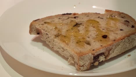 healthy toast with extra virgin olive oil drizzle on top, served on a white plate