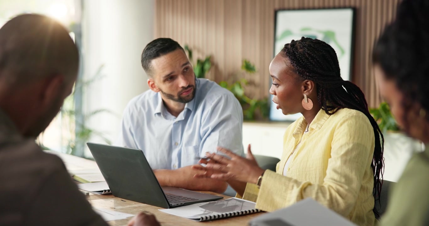 Diverse Business Team Collaborating on Project in Modern Office