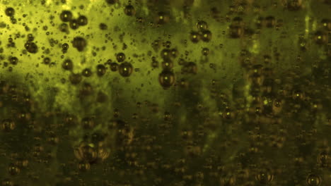 rising micro bubbles of a green fluid gel