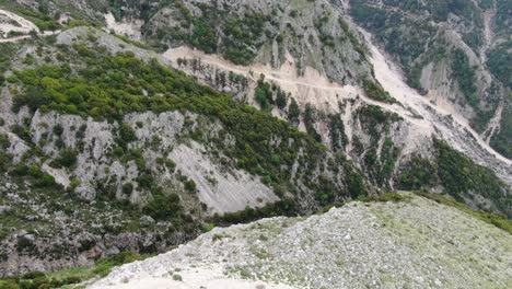 Drone-view-in-Albania-flying-over-a-green-and-rocky-mountain-from-top-view