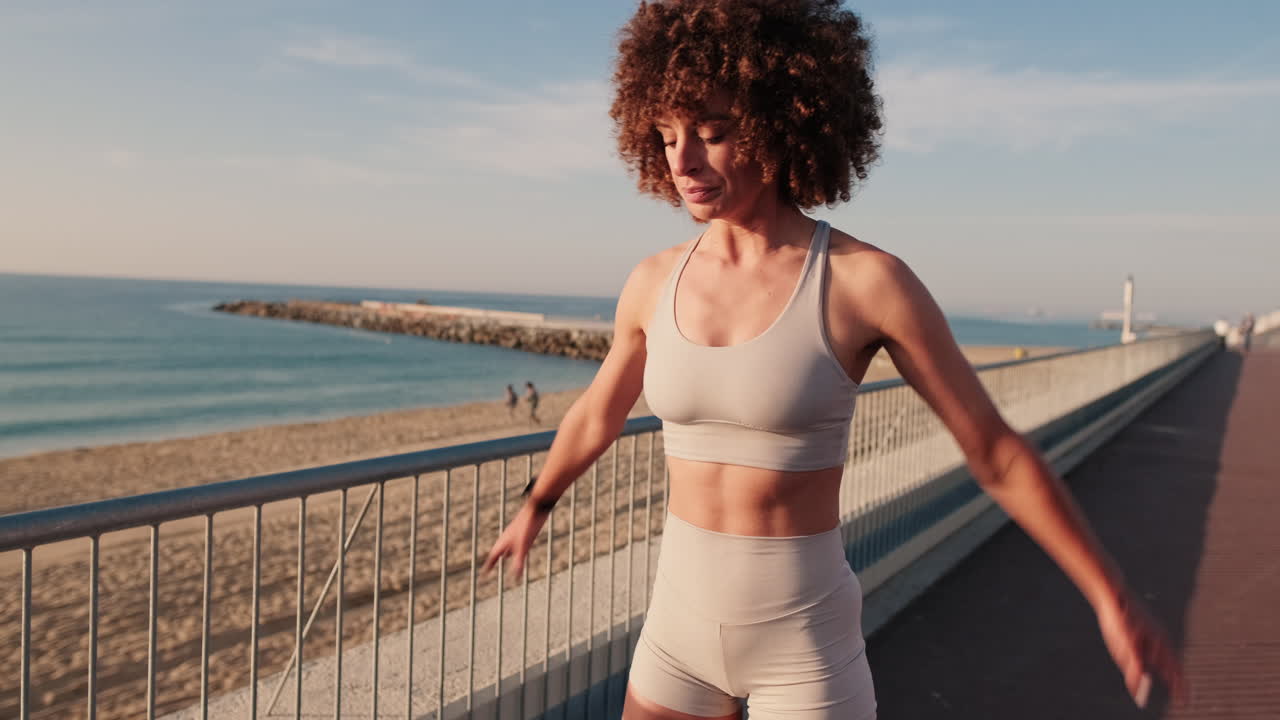 Young Woman Stretching Before Beach Workout