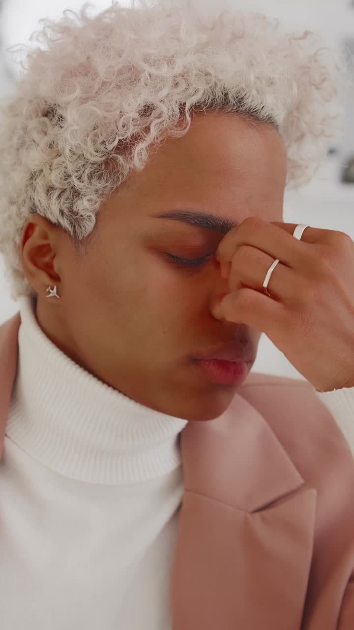 Emotional moment captured indoors with a person in a light jacket