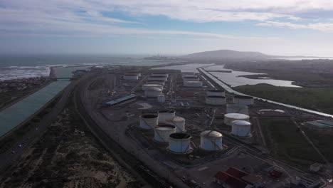 Vista-Aérea-De-Drones-Sobre-Un-Lugar-De-Almacenamiento-De-Gas-Petrolero-En-El-Fondo.-Canal-Costero