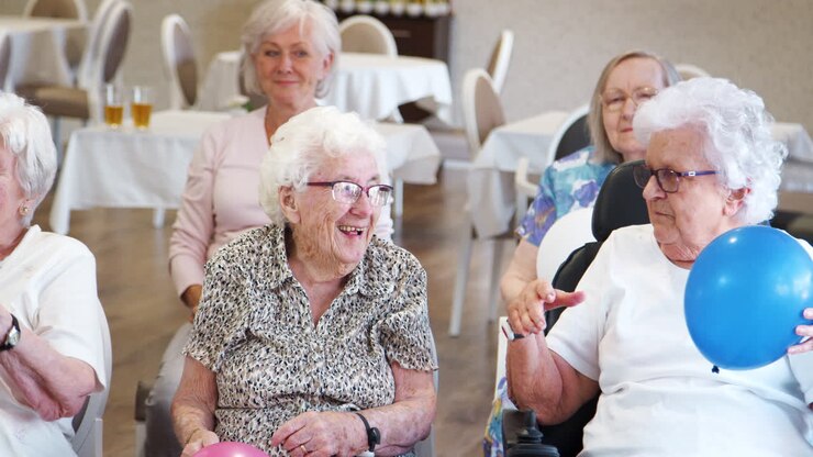Group Of Seniors Enjoying Fitness Class In Retirement Home