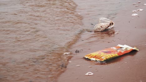 Close-up-of-Waste-and-Single-Use-Plastic-Lying-on-the-Shore