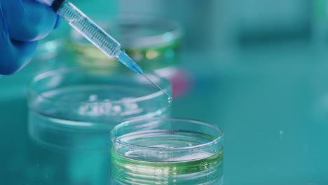 closeup of a scientist hand holding a syringe