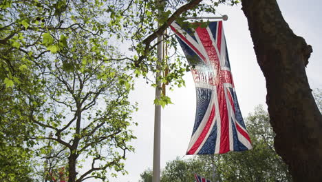 union flag hanging across pall mall street in the city of westminster, central london