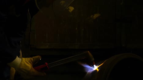 metalsmith using welding torch in workshop 4k