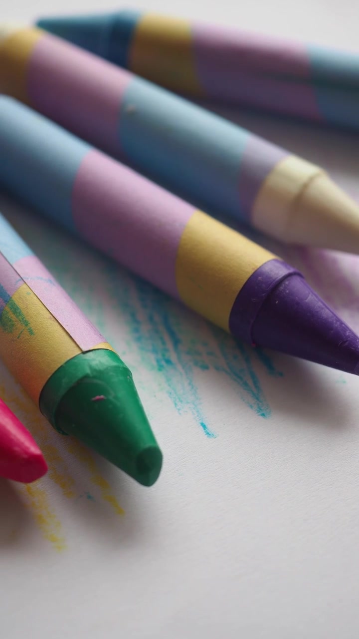 Colorful Wax Crayons Arranged on White Paper