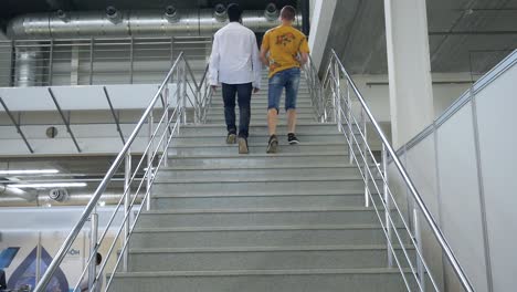 men walking up a large building staircase