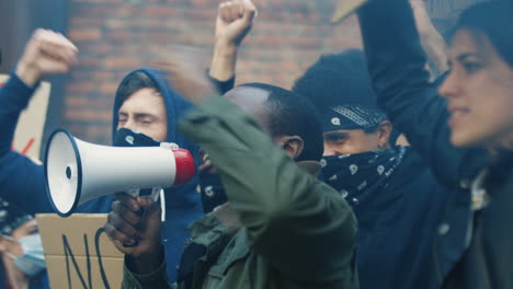 group of multiethnic people yelling in a protest against the racism in the street