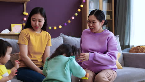 asian mothers talking in living room