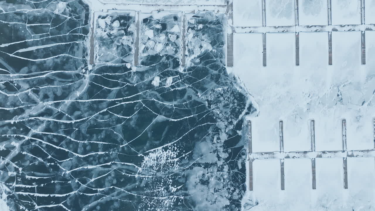 Aerial view of icy Bronte Harbour and Lake Ontario in winter