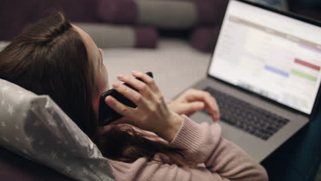 business woman call mobile phone while working on laptop