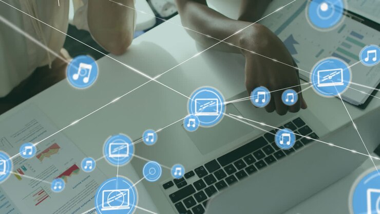 Animation of connected icons, overhead view of diverse coworkers analyzing reports on desk