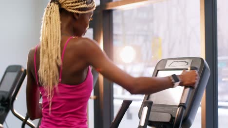 fit woman exercising on cross trainer