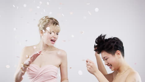 two women celebrating with confetti