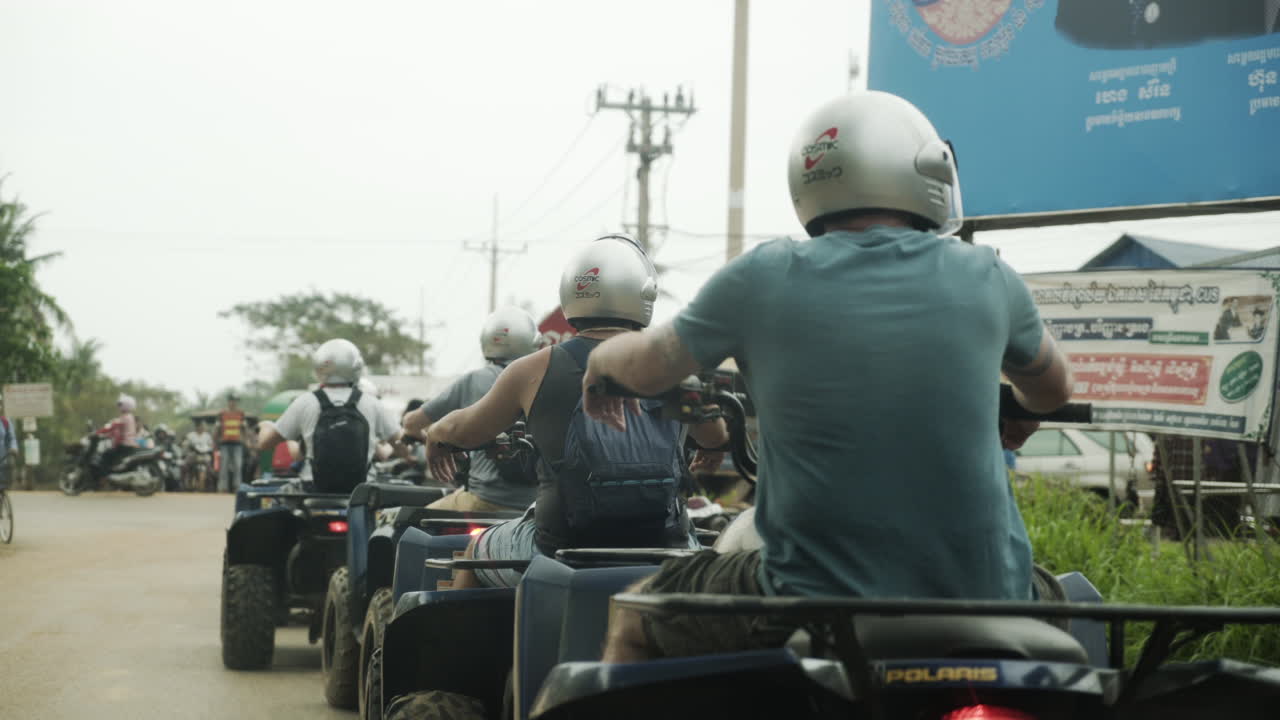 Group of ATV drivers waiting in traffic. Steady shot.