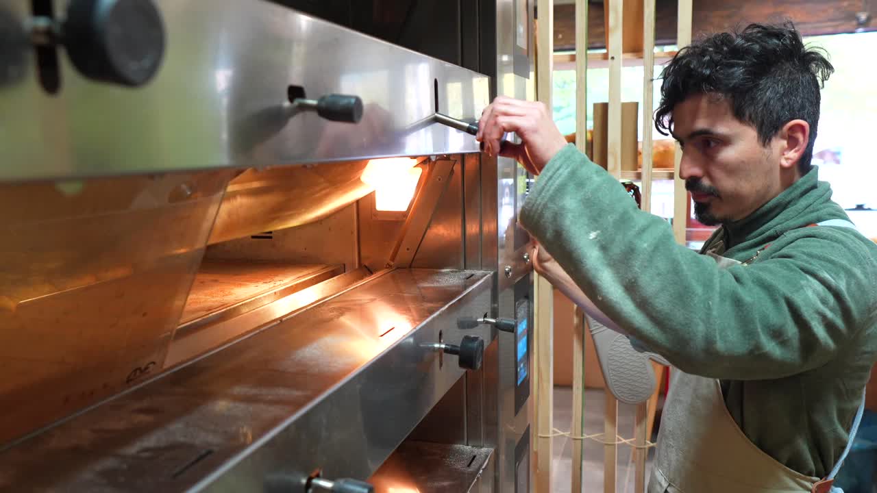 Baker operating a commercial oven