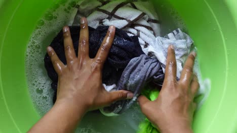 woman washing clothes by hand