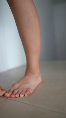 person standing with bare feet on floor