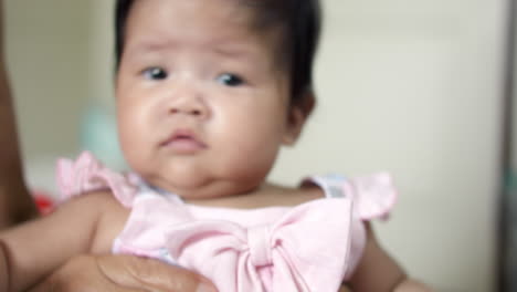 asian newborn baby trying to move.