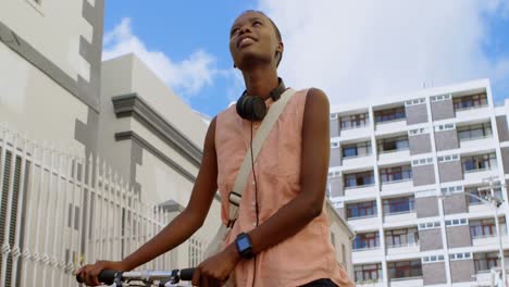 mujer caminando con bicicleta en la ciudad 4k
