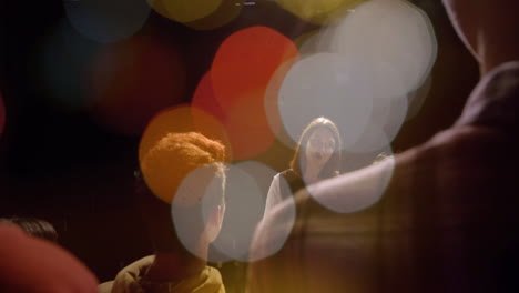 business woman presenting on dark stage, with animated bokeh lights floating above audience