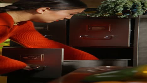 woman opening a drawer in a retro home office