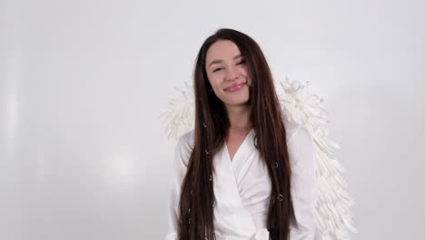 woman in white robe with angel wings