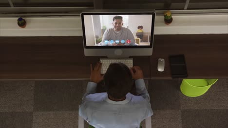 Overhead-view-of-man-having-a-video-conference-