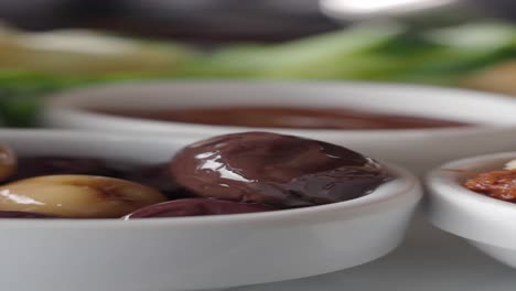 close-up of a bowl of green and black olives